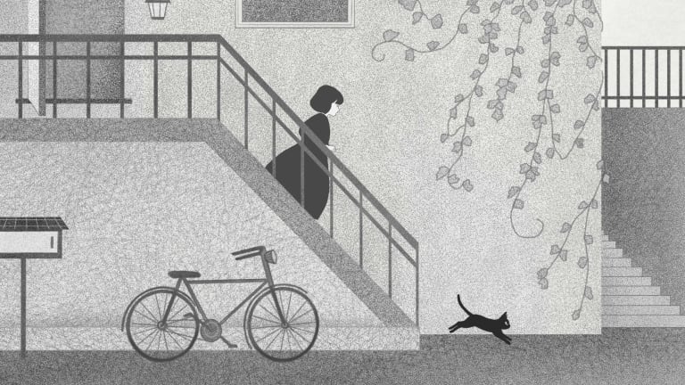 黑色和灰色的街景，一个女人走在外面的楼梯.  有一只黑猫在她面前跑开了. 有一辆自行车靠在大楼上. 