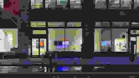 Exterior view of SVA Flatiron Windows. Monitors and paintings are in the windows.