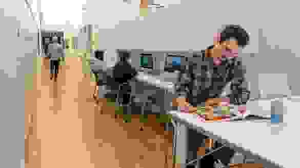 People congregating in an open plan, community oriented lounge.