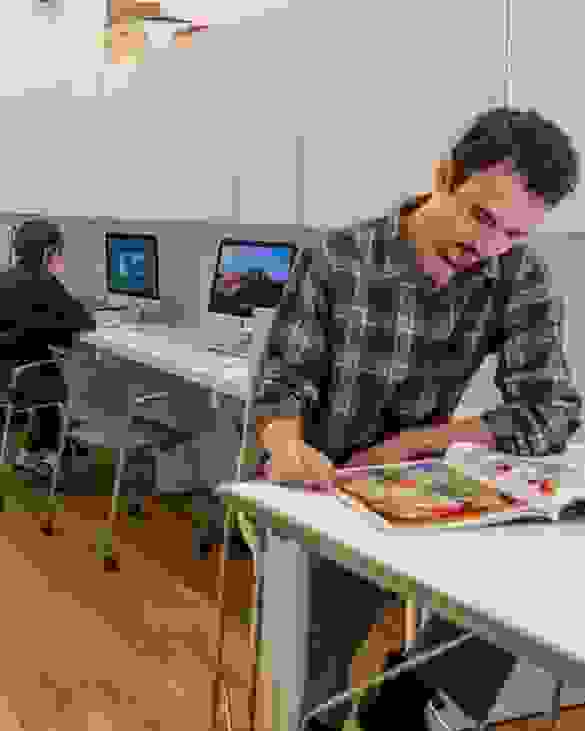 People congregating in an open plan, community oriented lounge.