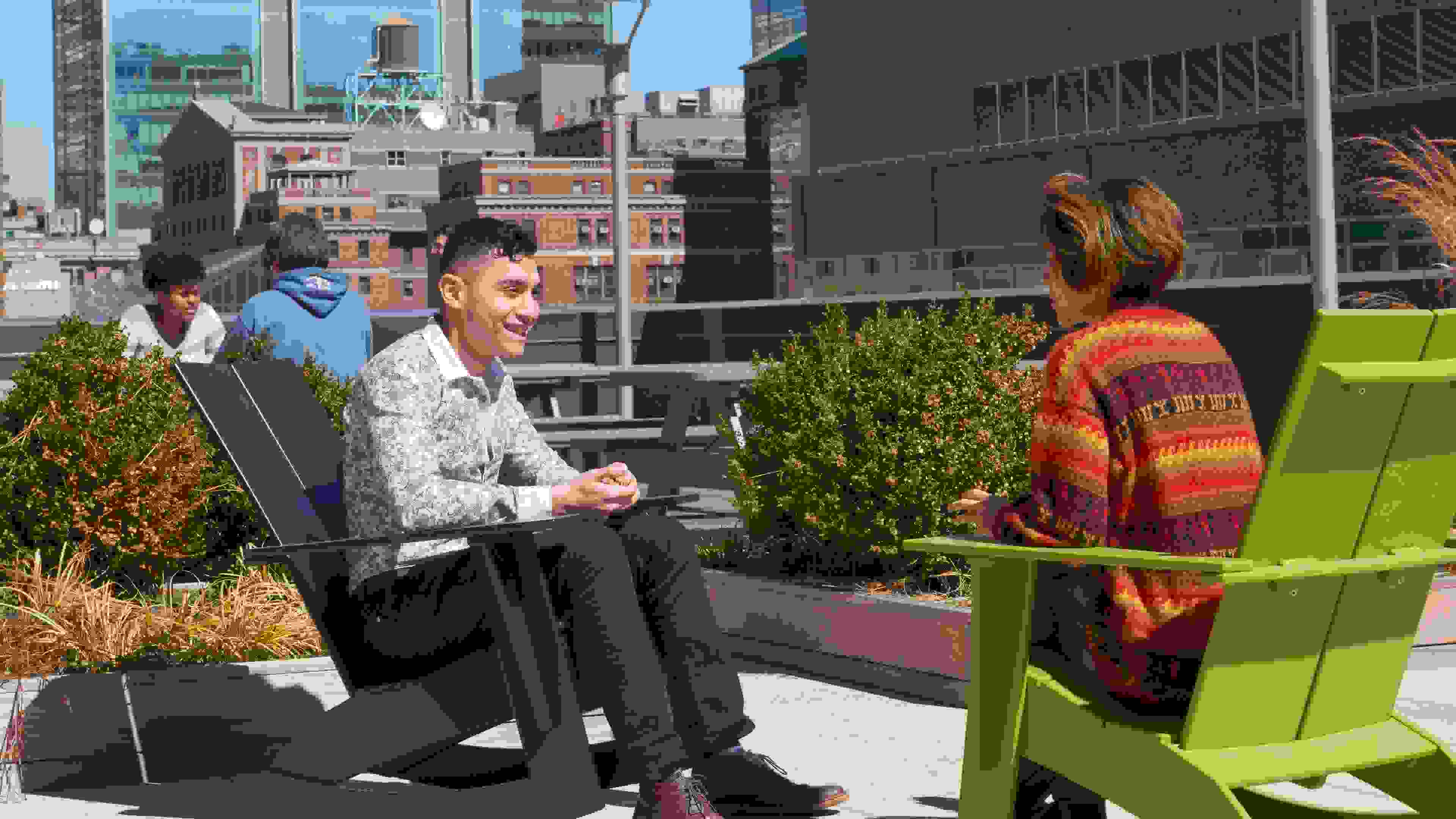 Students sitting on the terrace of the 24th Street Residence.