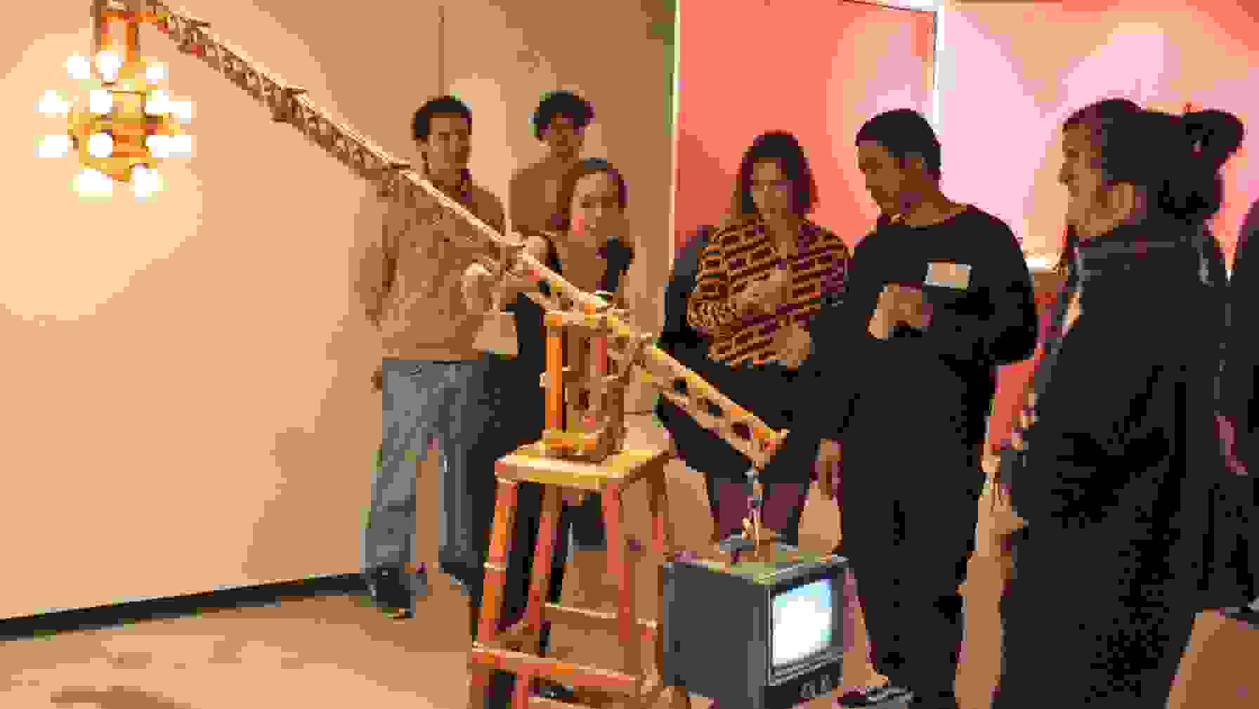 Class discussing a kinetic video sculpture