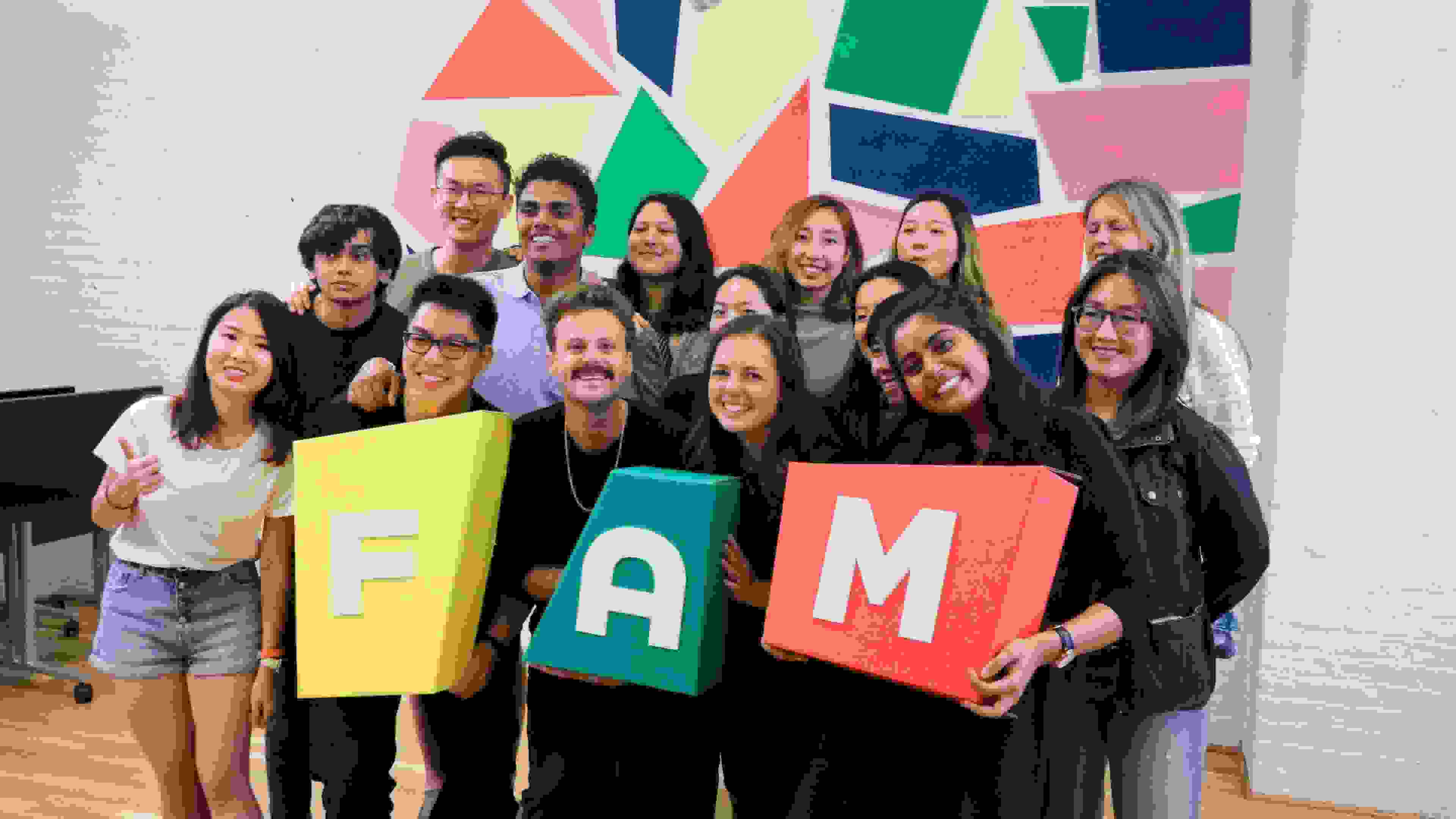 SVA MFA Design students holding a sign that says FAM