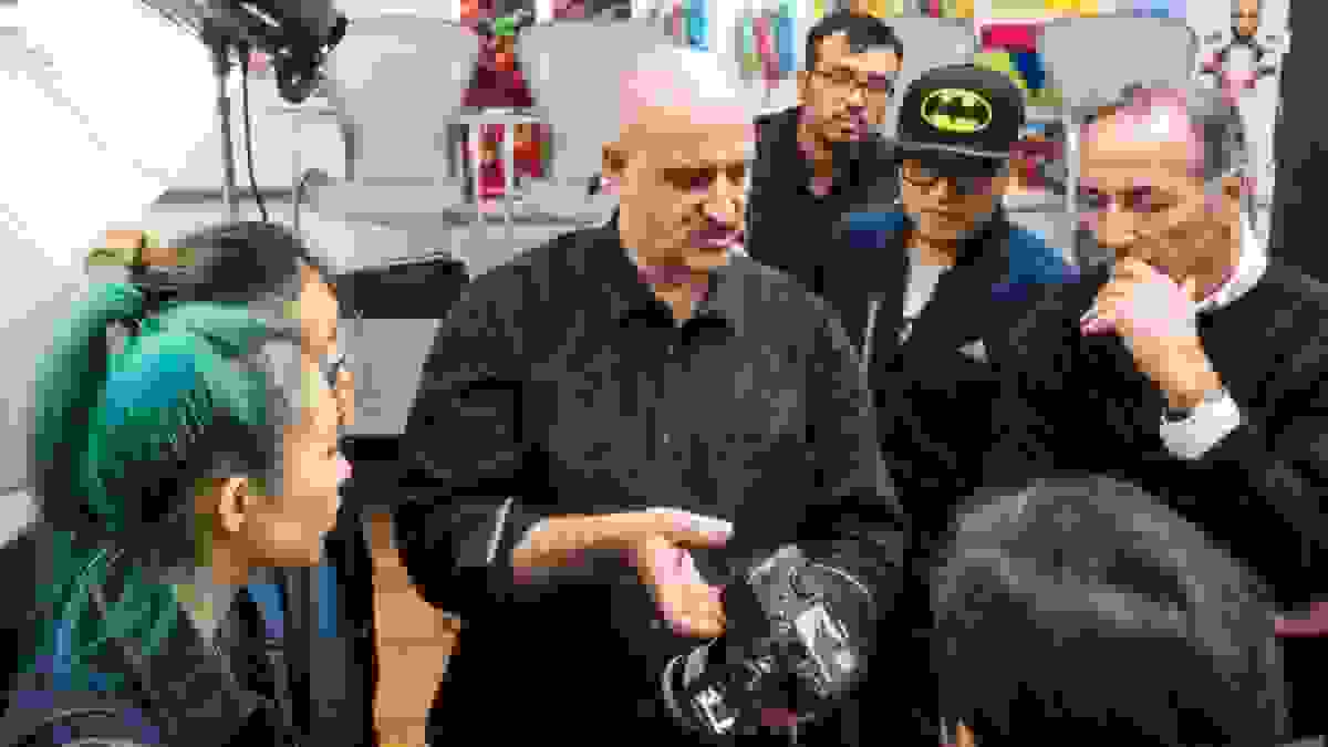 Professor demonstrating camera to students