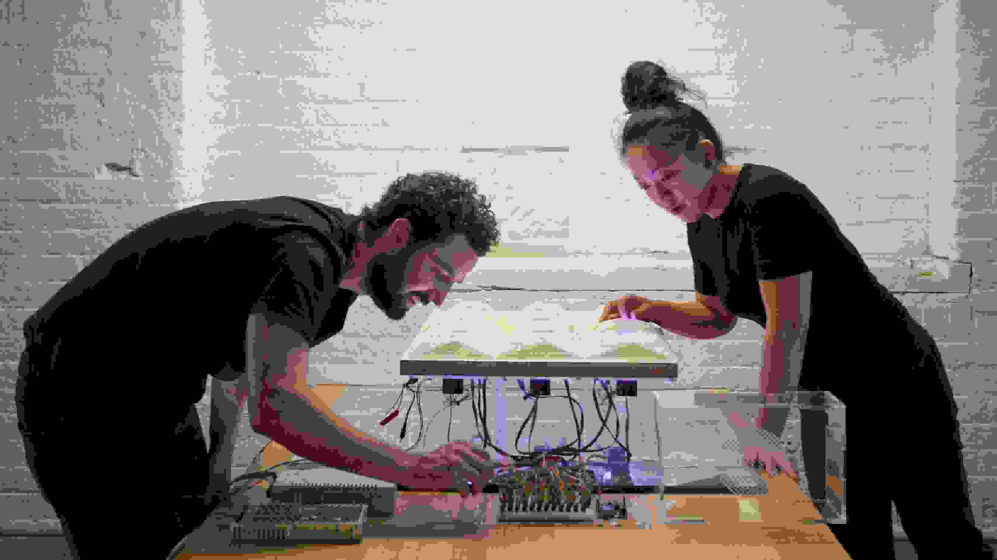 Students wiring an electronic illuminated art piece