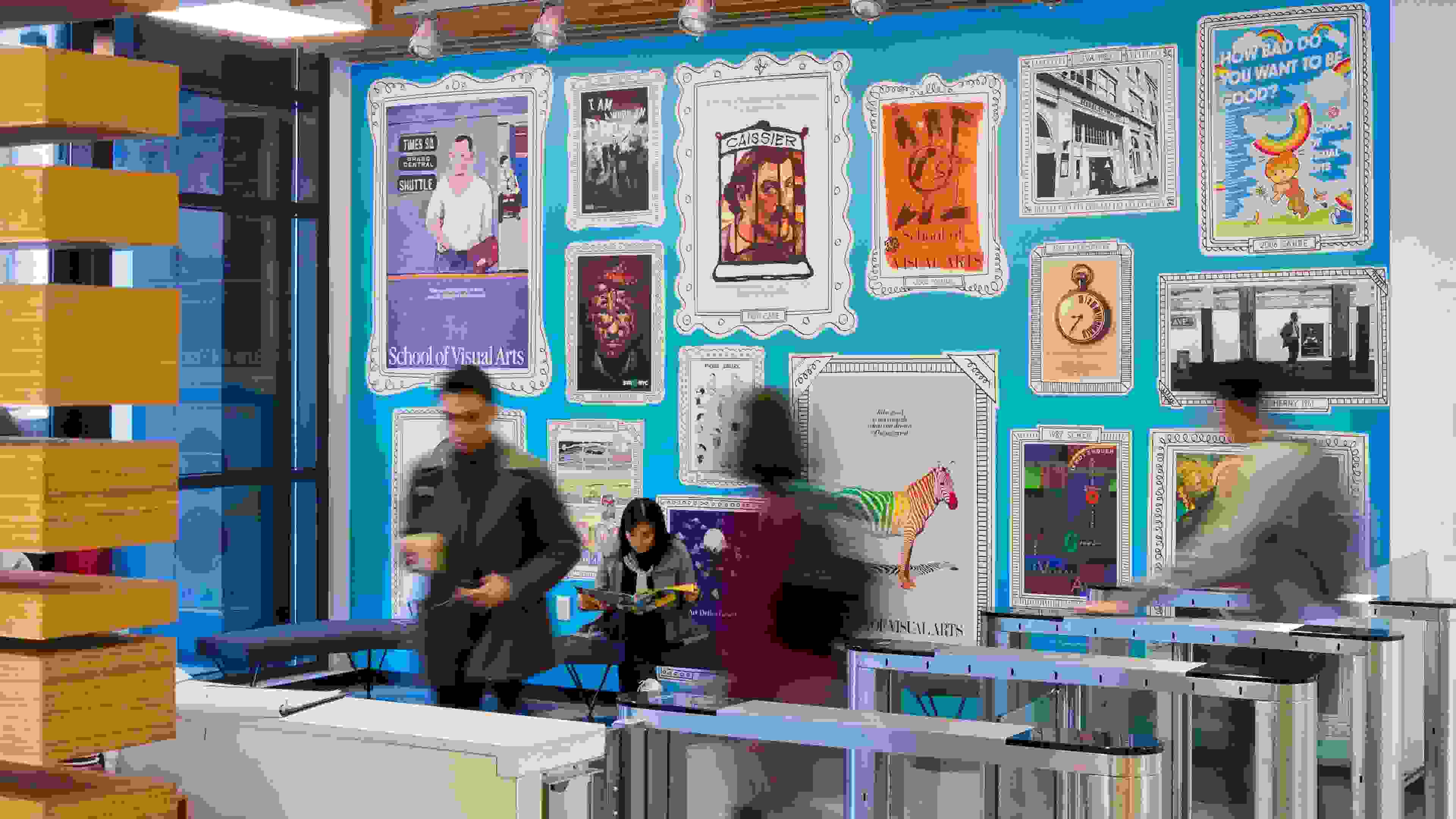 Interior of a residence hall adorned with archival SVA subway posters on a sky blue wall