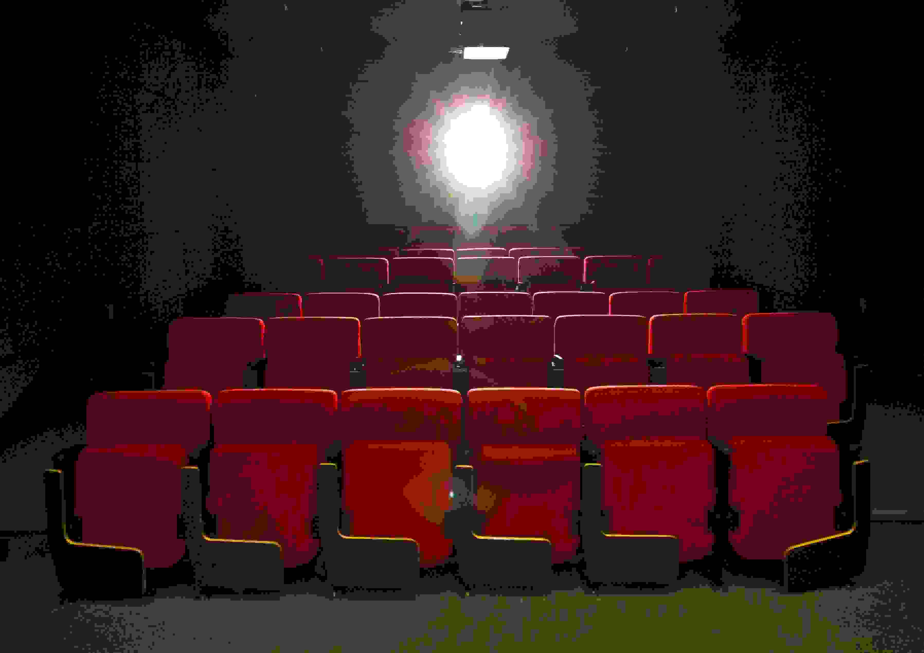 Empty theater with red seats.