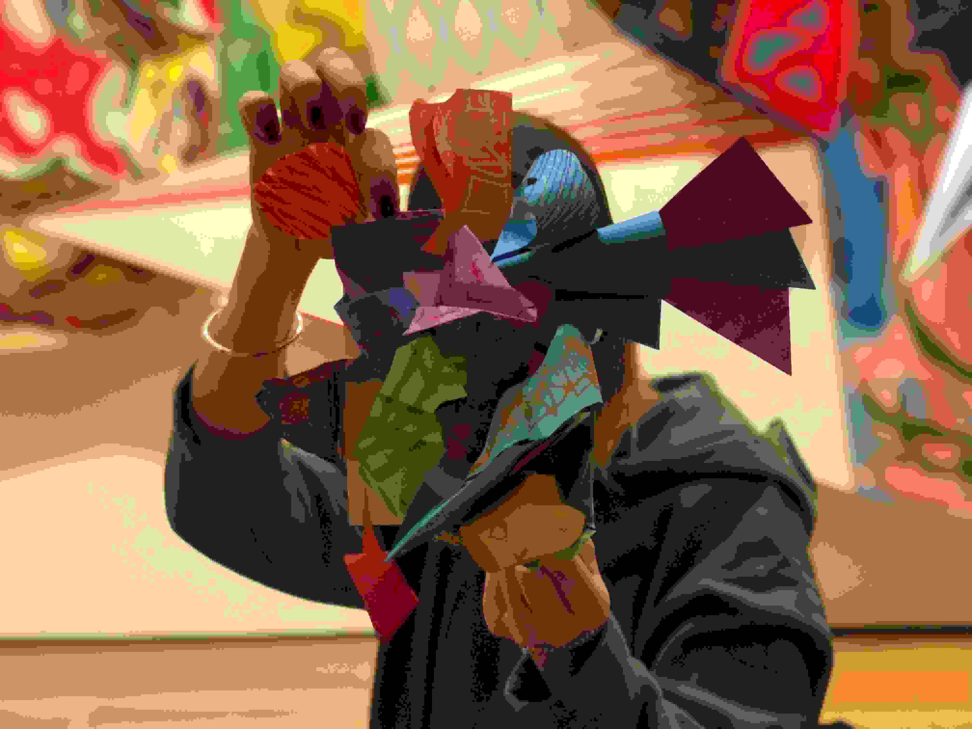 Person holding up a paper sculpture