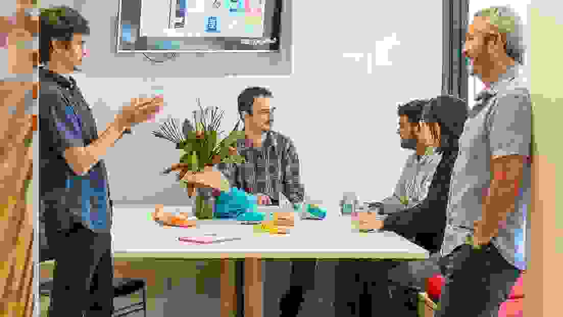 People congregating in an open plan, community oriented lounge.