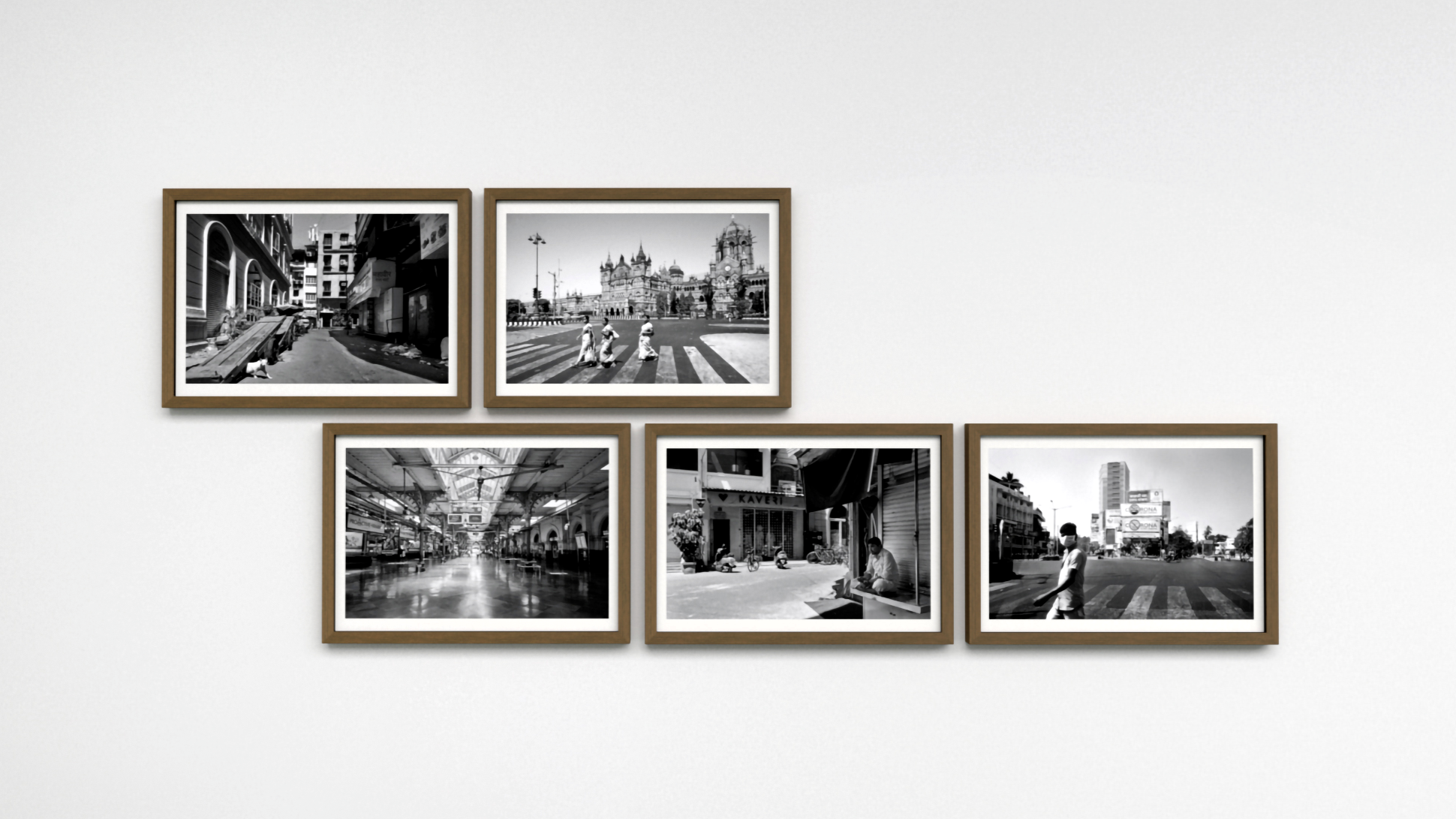 Black and white photographs in brown wooden frames.