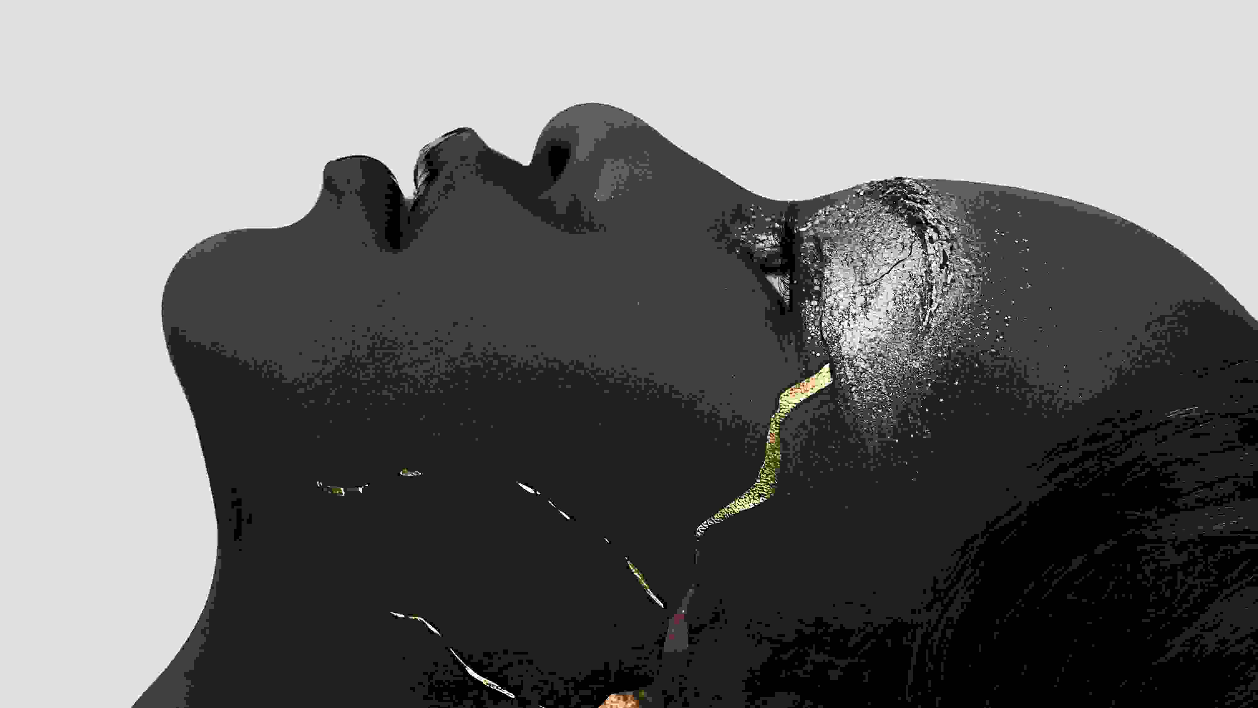 A close-up profile view of an African woman staring towards the top of the frame. She's wearing silver glittery eyeshadow. A gold crack goes up the side of her cheek.