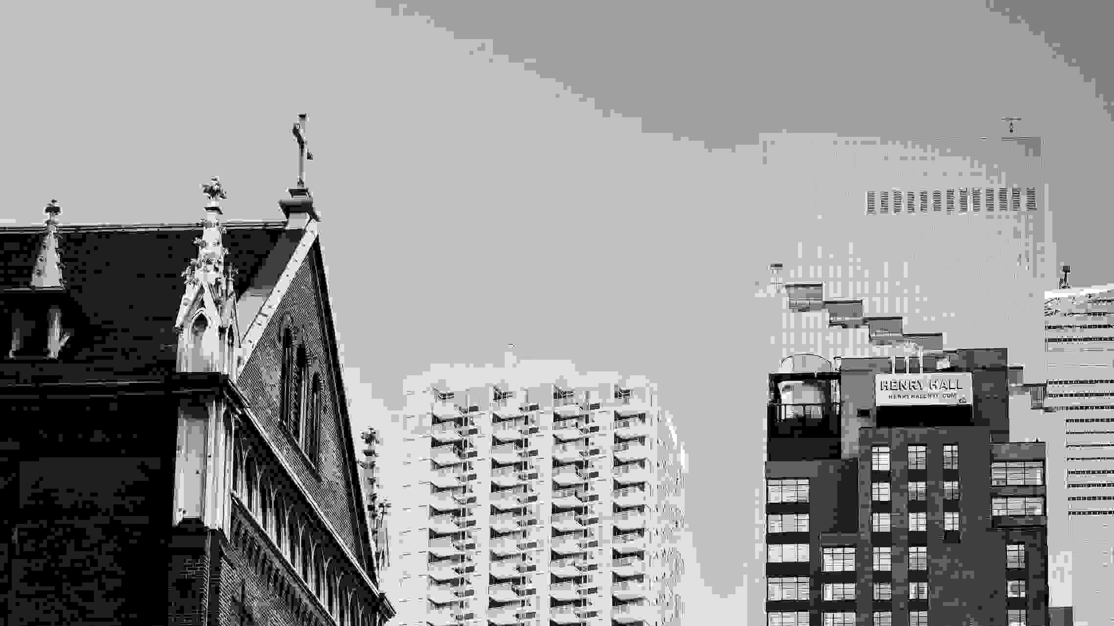 A black-and-white photo of a church and surrounding buildings.