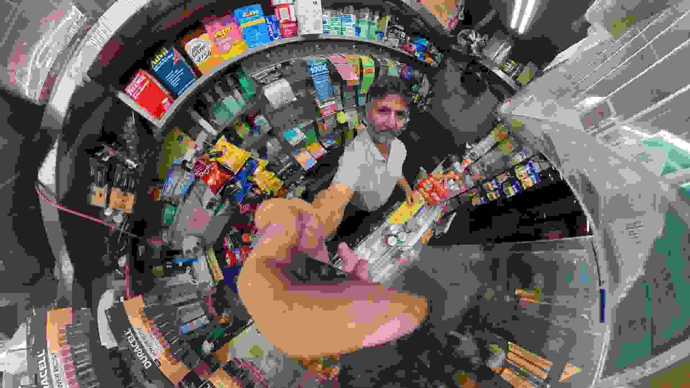 a 360 environmental portrait photograph of the interior of a halal cart and its owner.