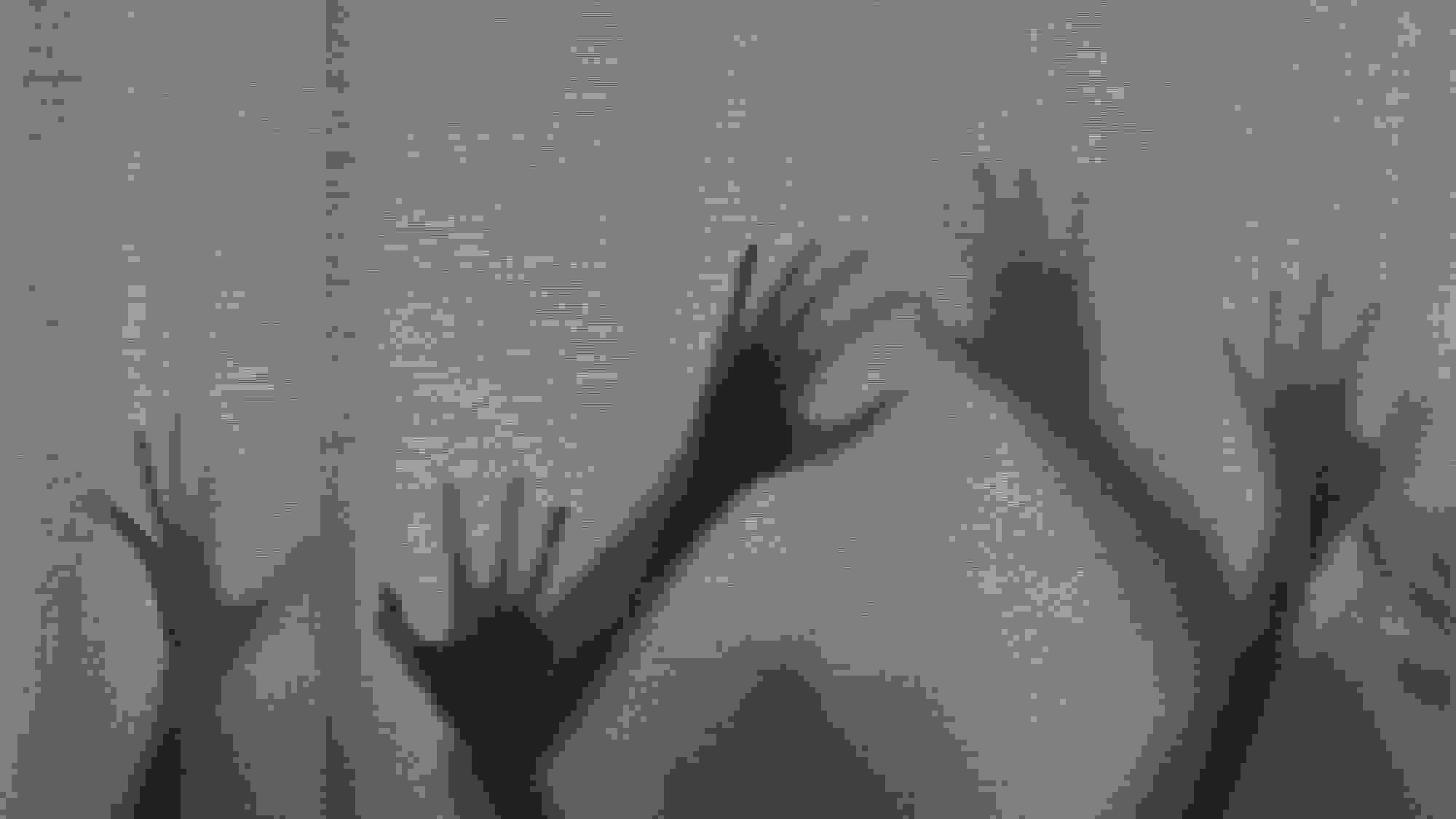 A black-and-white photograph of silhouetted hands reaching upwards from behind a curtain