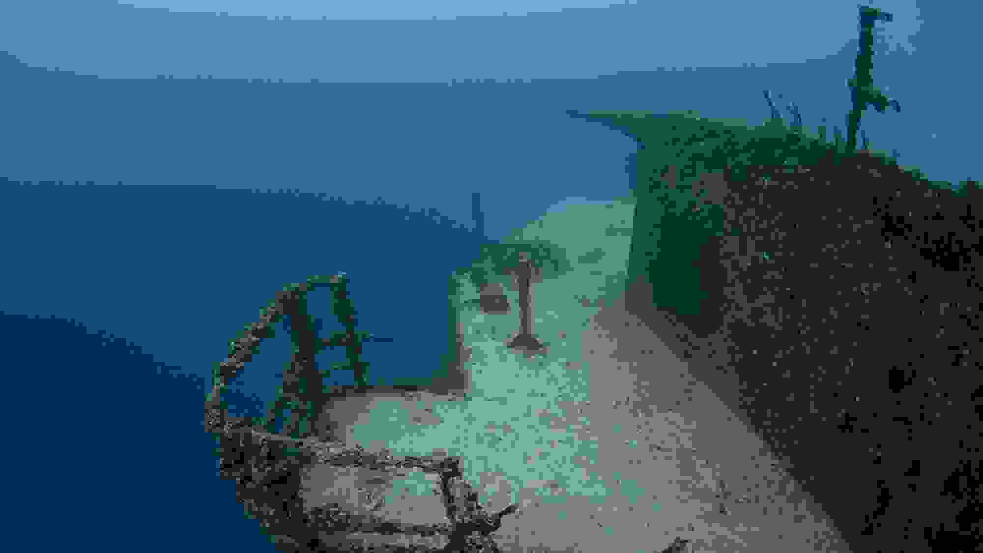 A documentary photograph of the side of an undersea artificial reef boat.