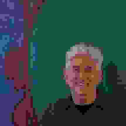 man in front of painting