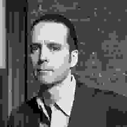 person in  a suit not smiling looking at the camera