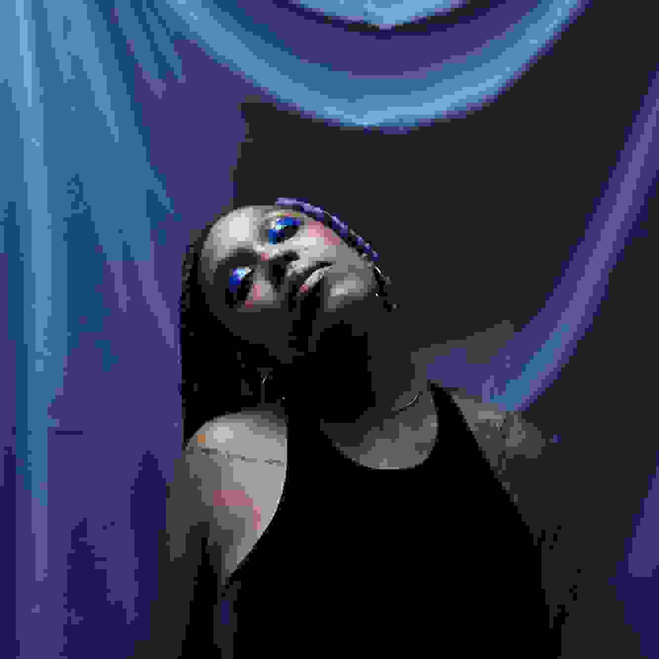 person in front of blue fabric