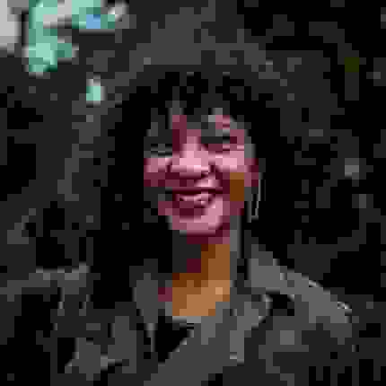 Jodie Lyn-Kee+Chow portrait, smiling in a green top 