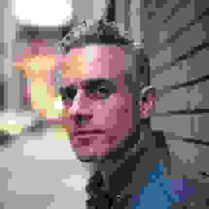 Portrait of Miguel Luciano with blurred background 