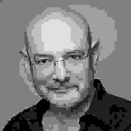 a person with glasses and a beard looking at the camera