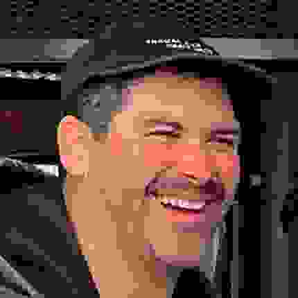 Portrait of Victor Kerlow wearing a black cap and smiling
