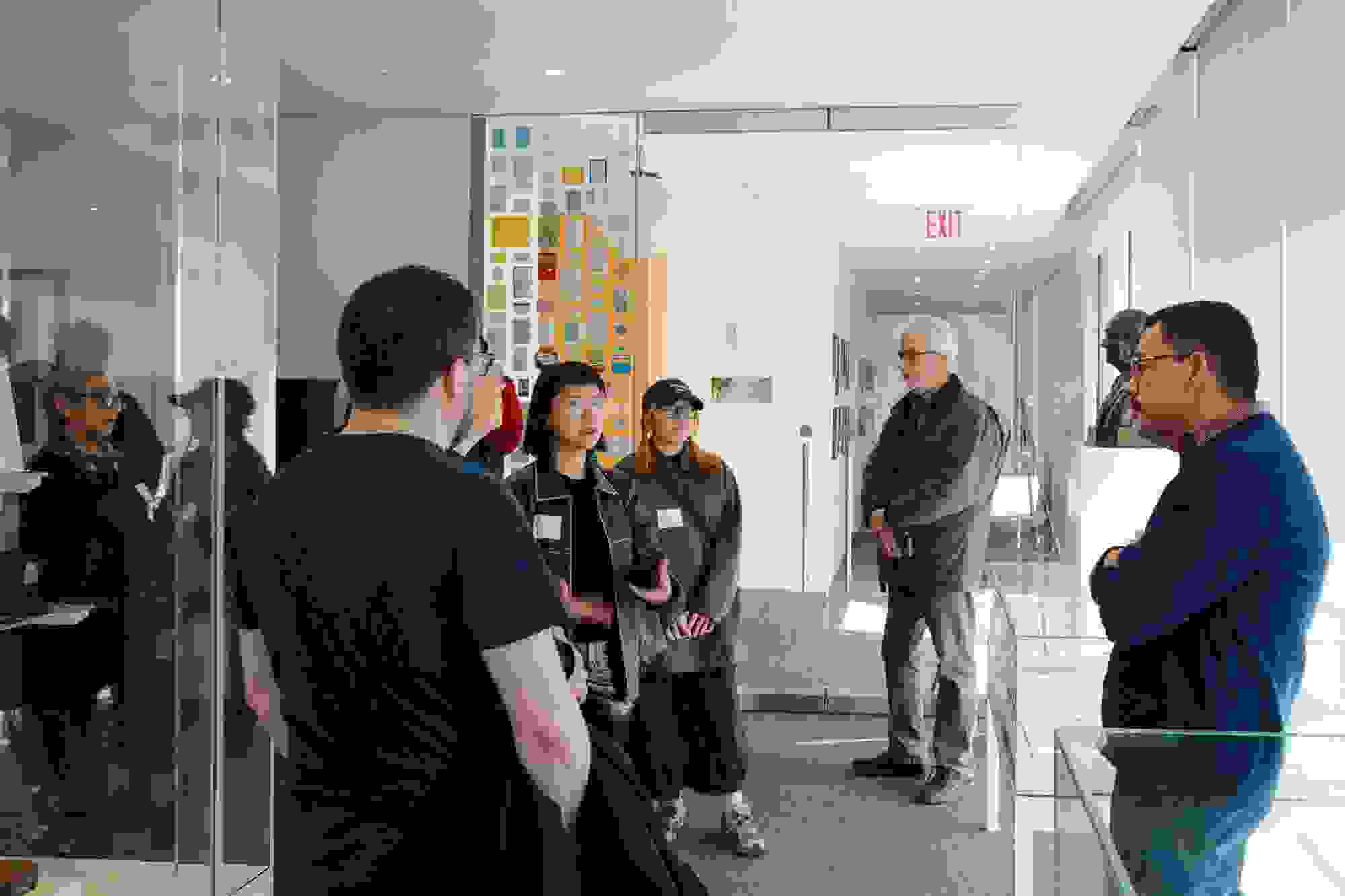 A photo from a class visit to the New York Times headquarter in New York City, where the Masters in Digital Photography students are inquiring about the history of the famed newsroom.