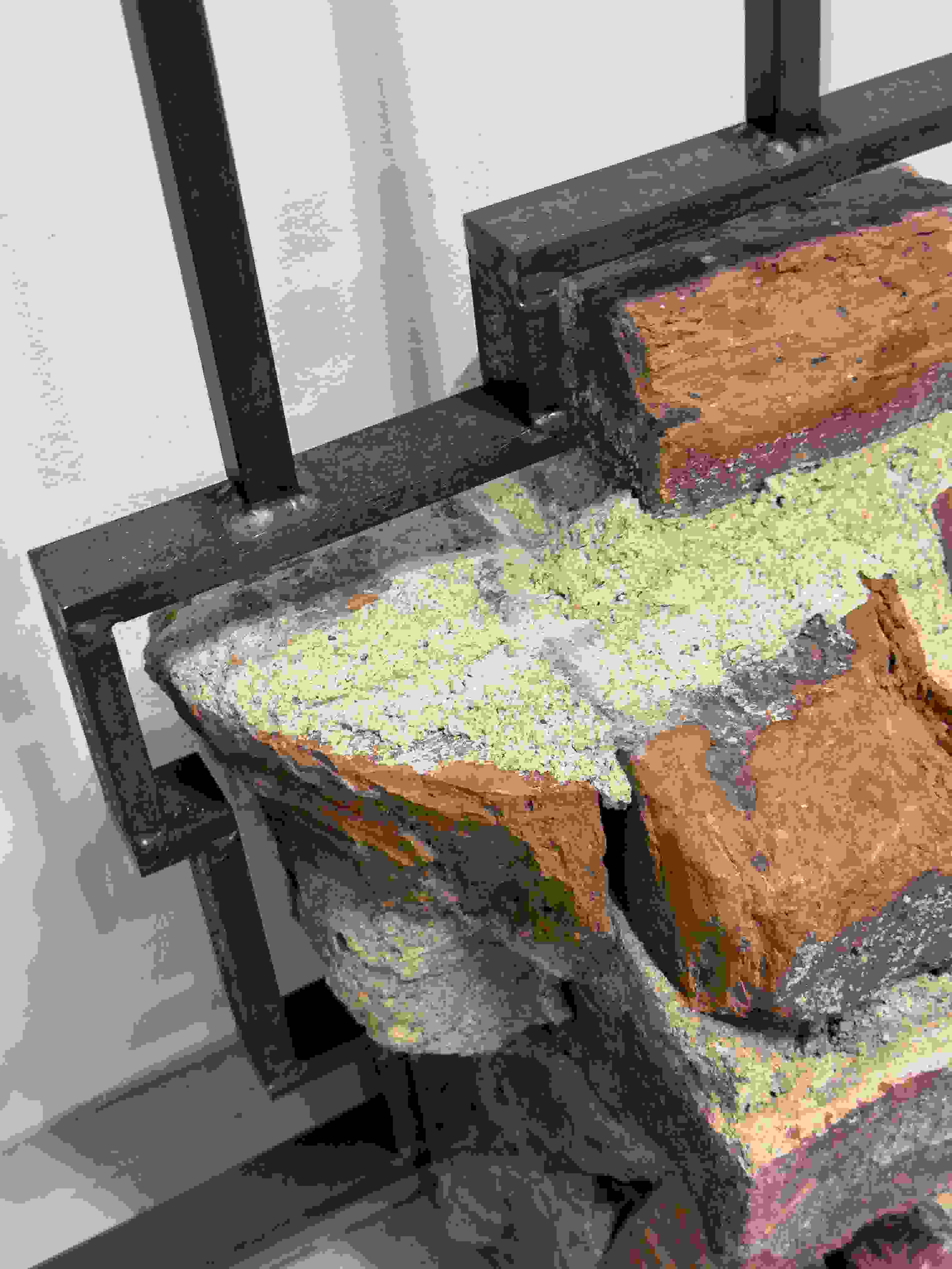 Detail image of a sculpture made of bricks over an iron armature.