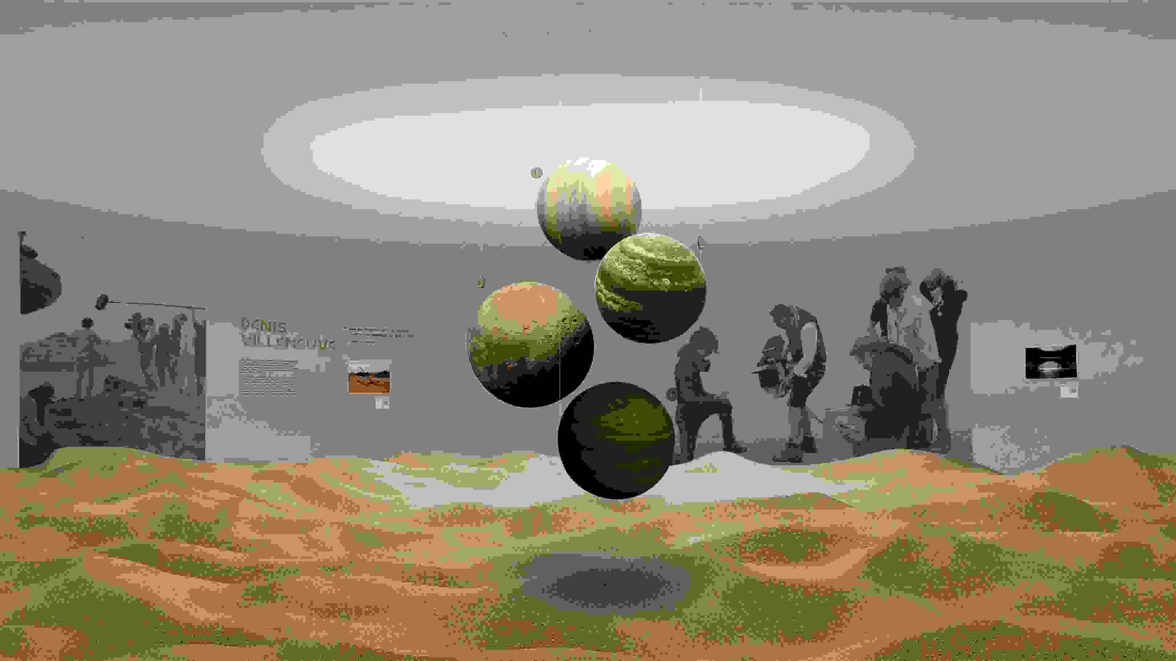 Rendering of an exhibition design for the film director Denis Villeneuve, which features a huge, undulating sand installation and planet-like orbs suspended from the ceiling.