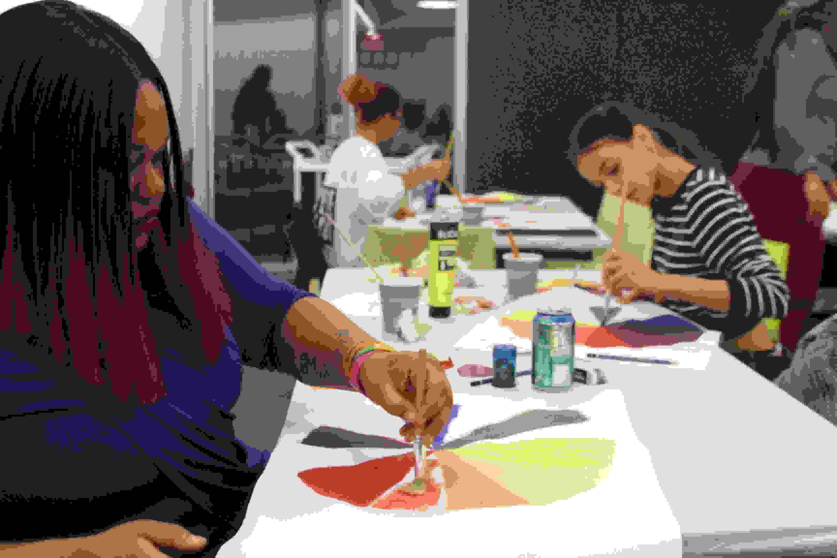 <p "="">A photo of Night Studio students painting color wheels.