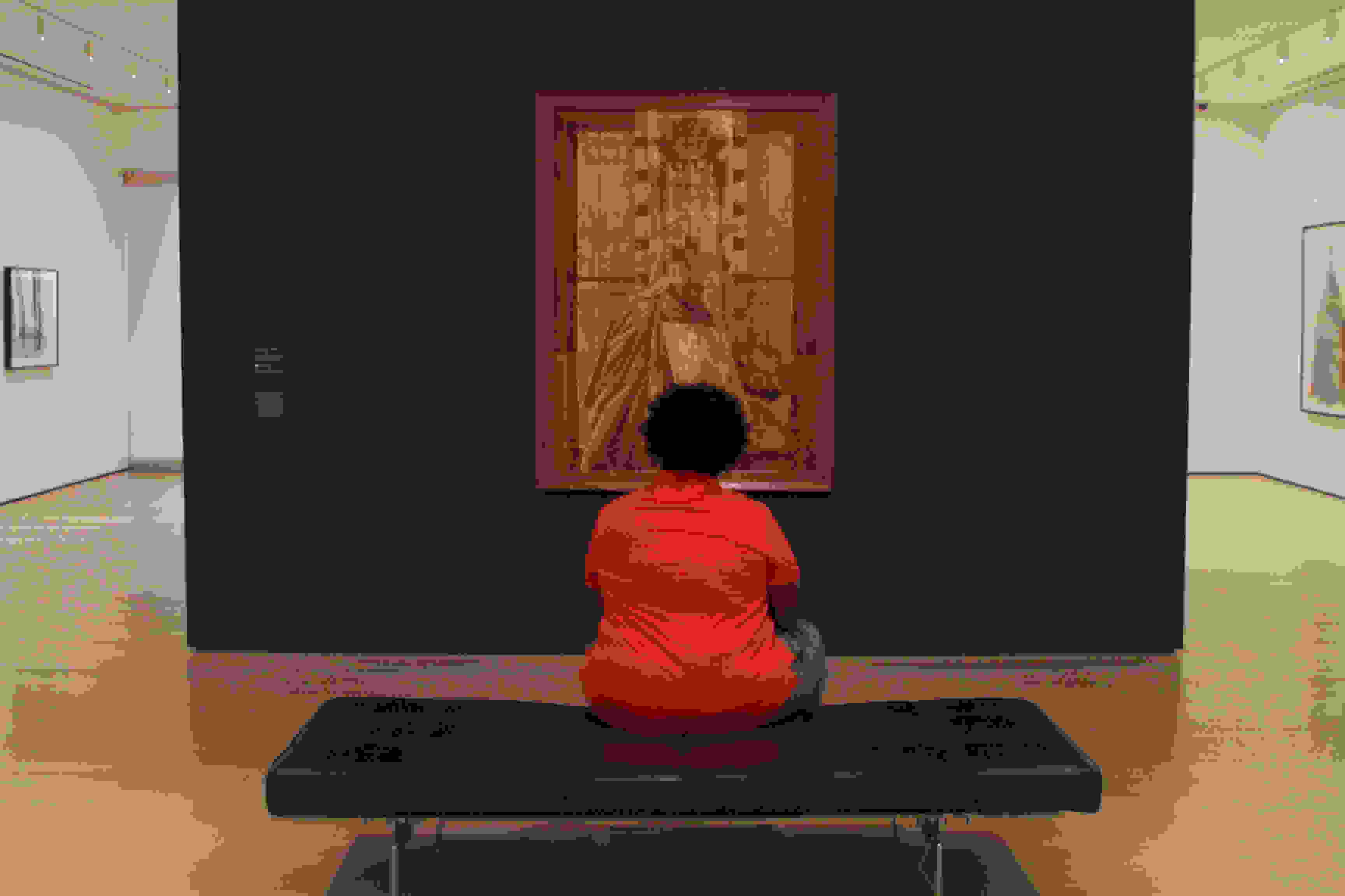 <p "="">A Night Studio student sits alone and looks at a painting in one of MoMA's galleries.<span class="redactor-invisible-space" "=""></span>