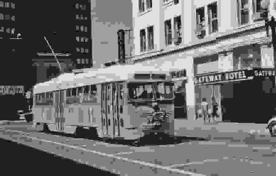 Old trolley passing Gateway Hotel.