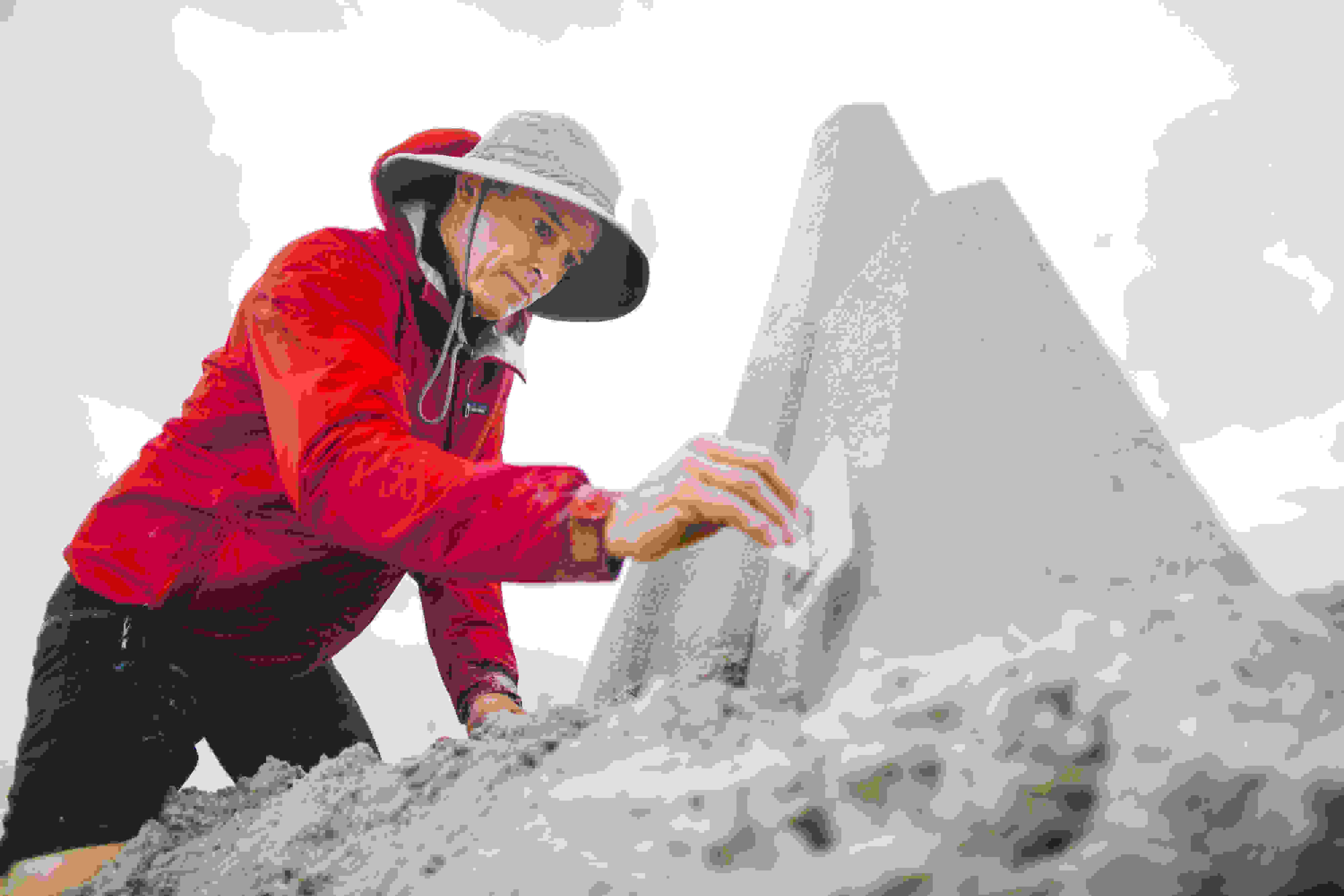 Seibert uses a Plexiglas tamper to form a sandcastle's wall.