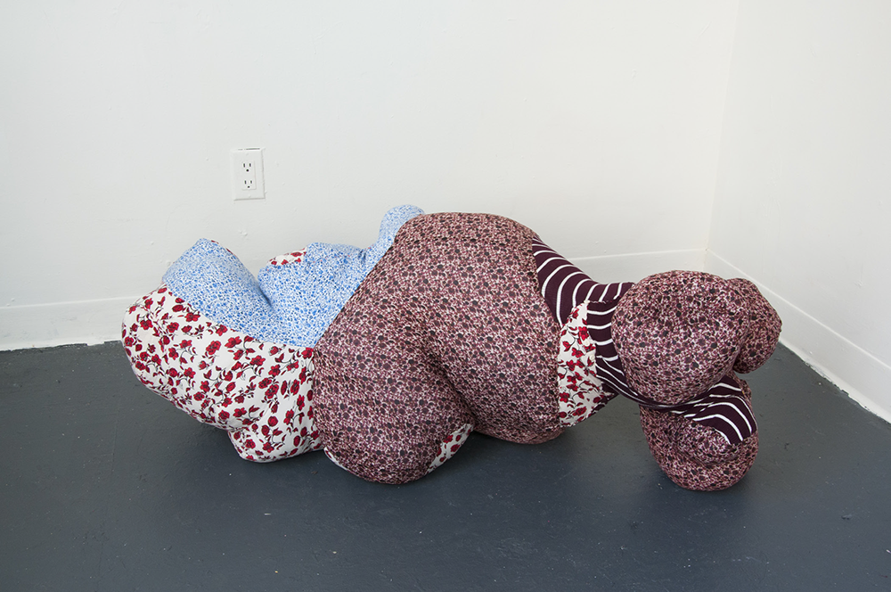 <p "="">An abstract sculpture made of stitched-together secondhand fabrics.
