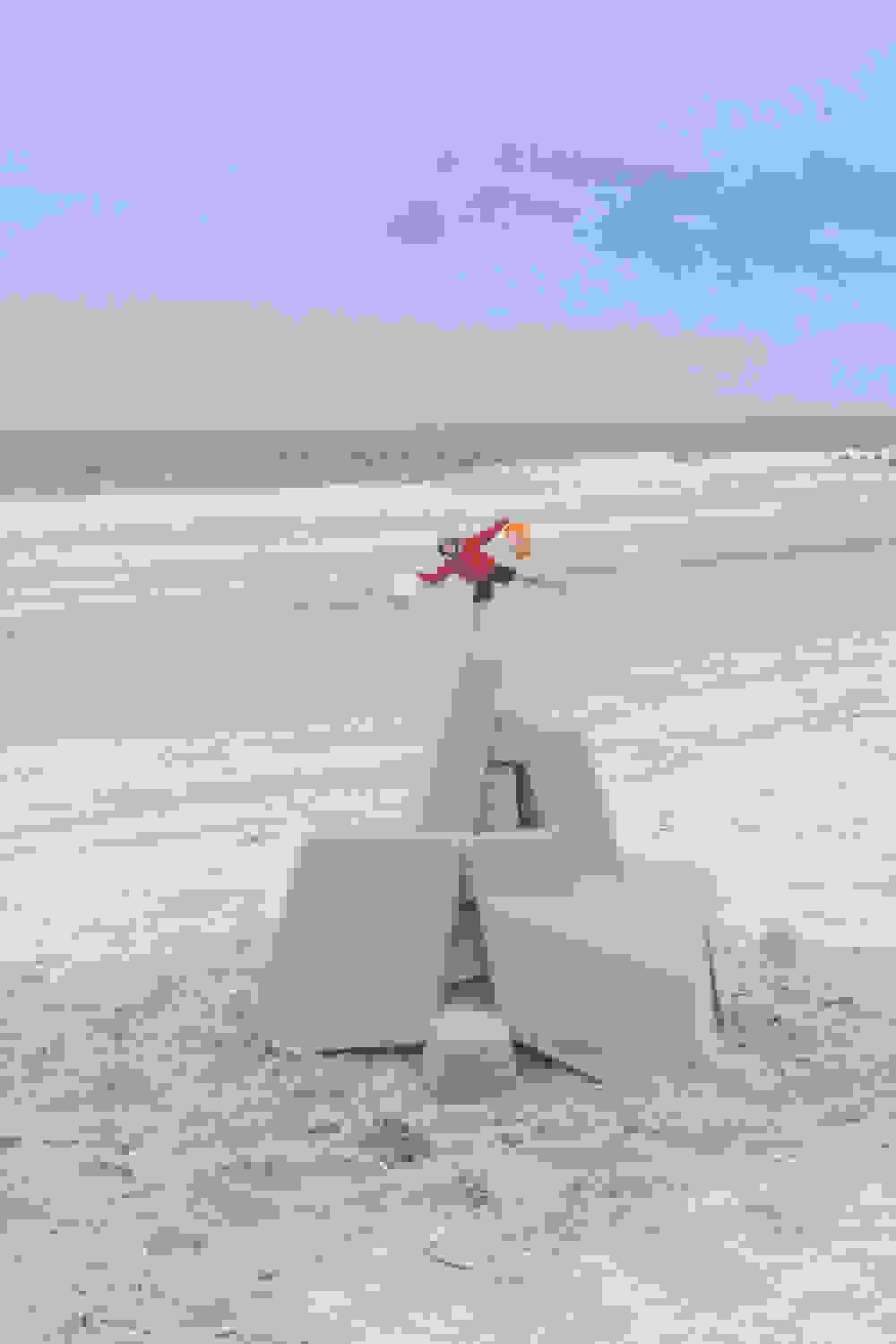 <p "="">Seibert poses for a photograph with his sandcastle and buckets.