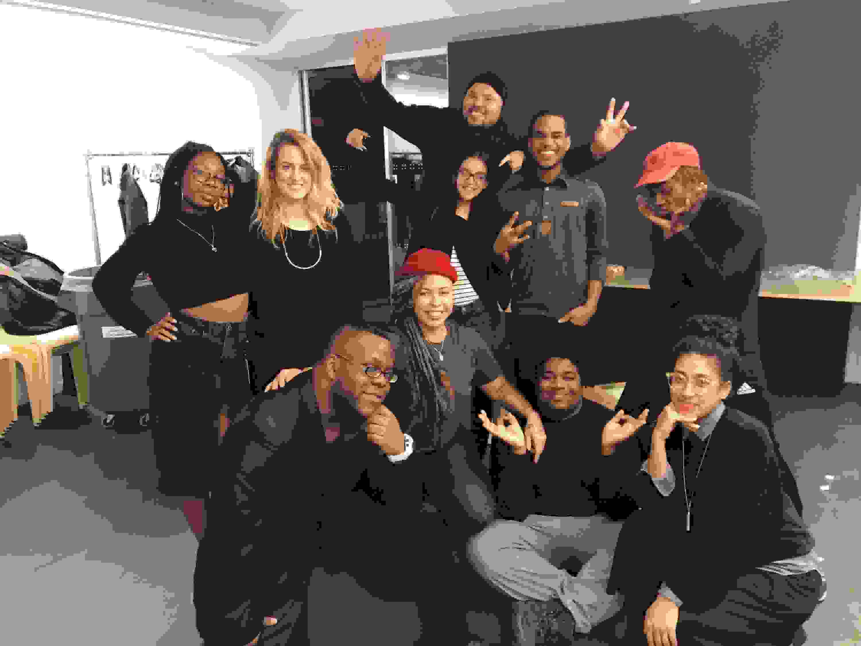 <p "="">Several people gather together and smile for the camera.