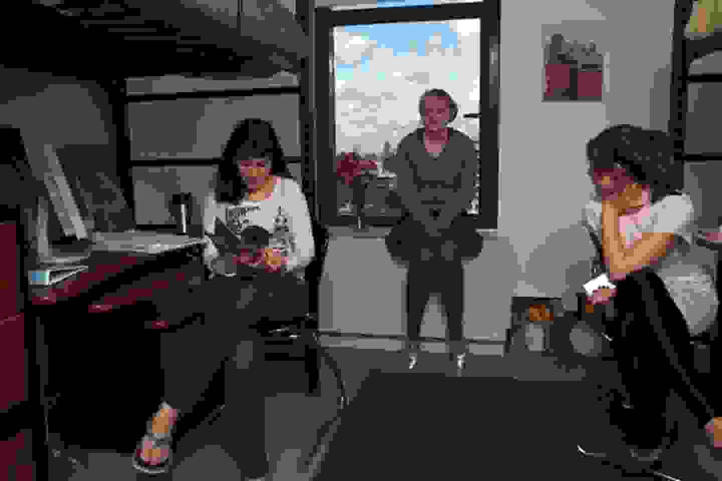 Three students in a dorm room