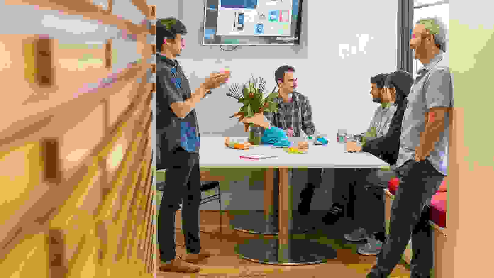 People congregating in an open plan, community oriented lounge.