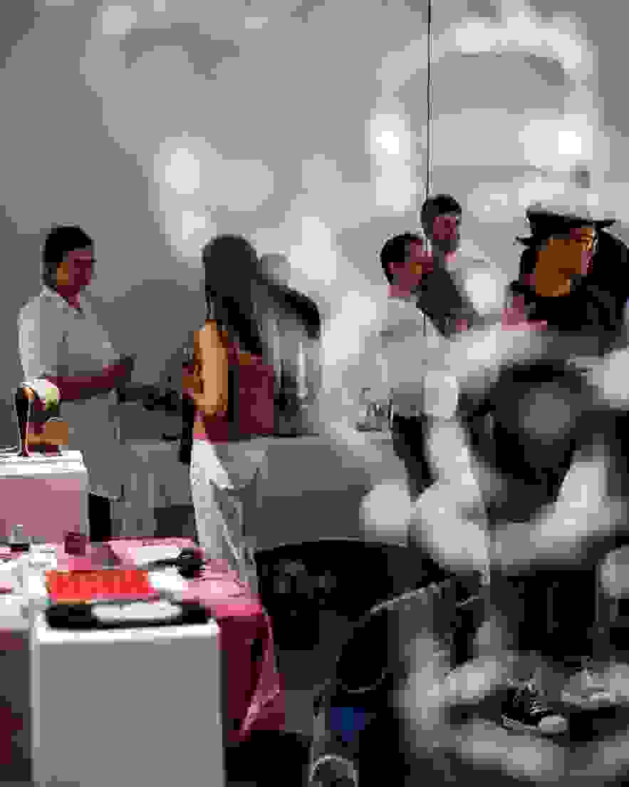 Students and professor in studio with art installation