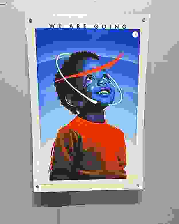 One of the ARTEMIS II posters designed by SVA students on a gray wall.