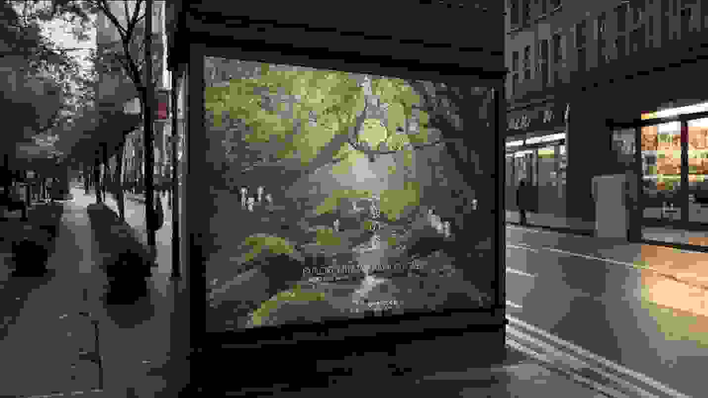 A mock-up of an advertising billboard on a newsstand; a verdant forest with whimsical creatures sitting on a tree branch and says "EXPLORE MIYAZAKI HAYAO'S FOREST."