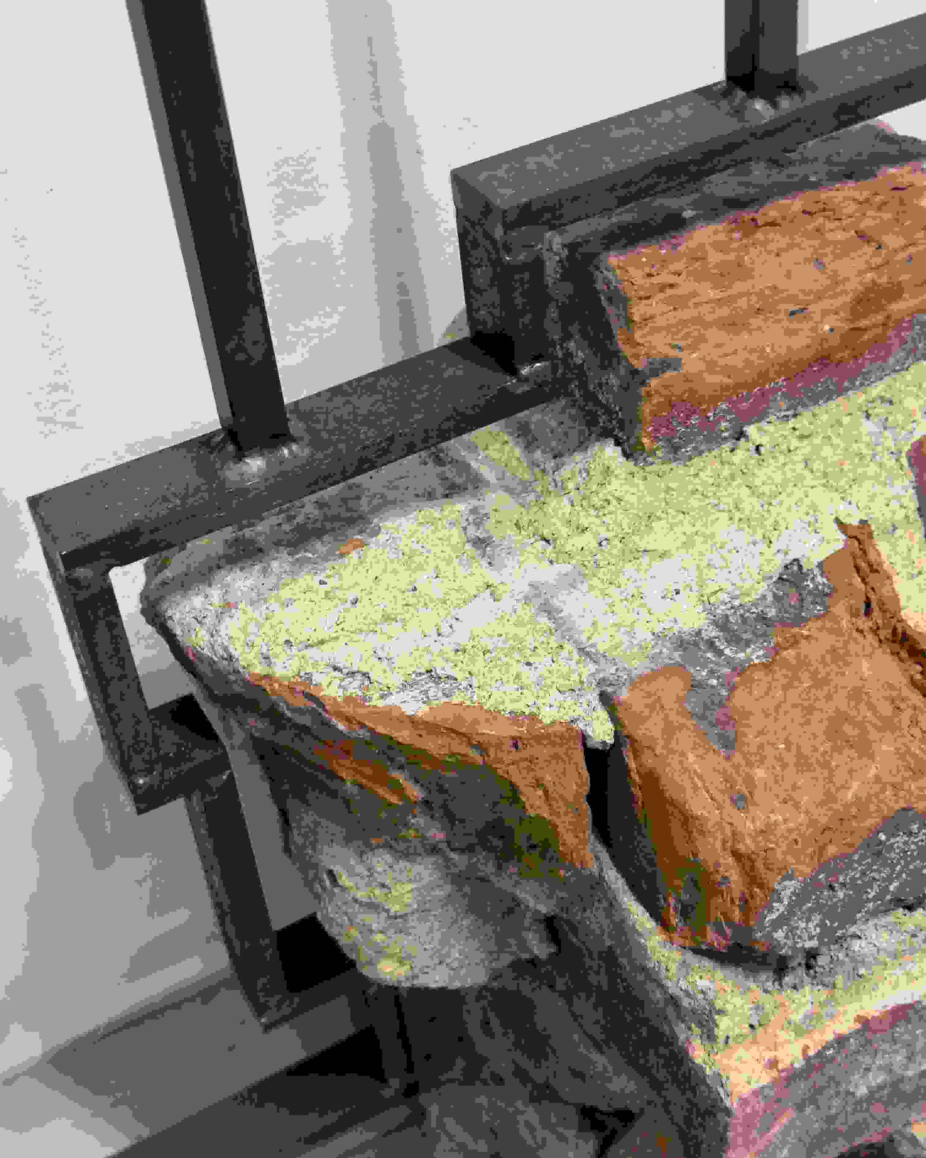 Detail image of a sculpture made of bricks over an iron armature.