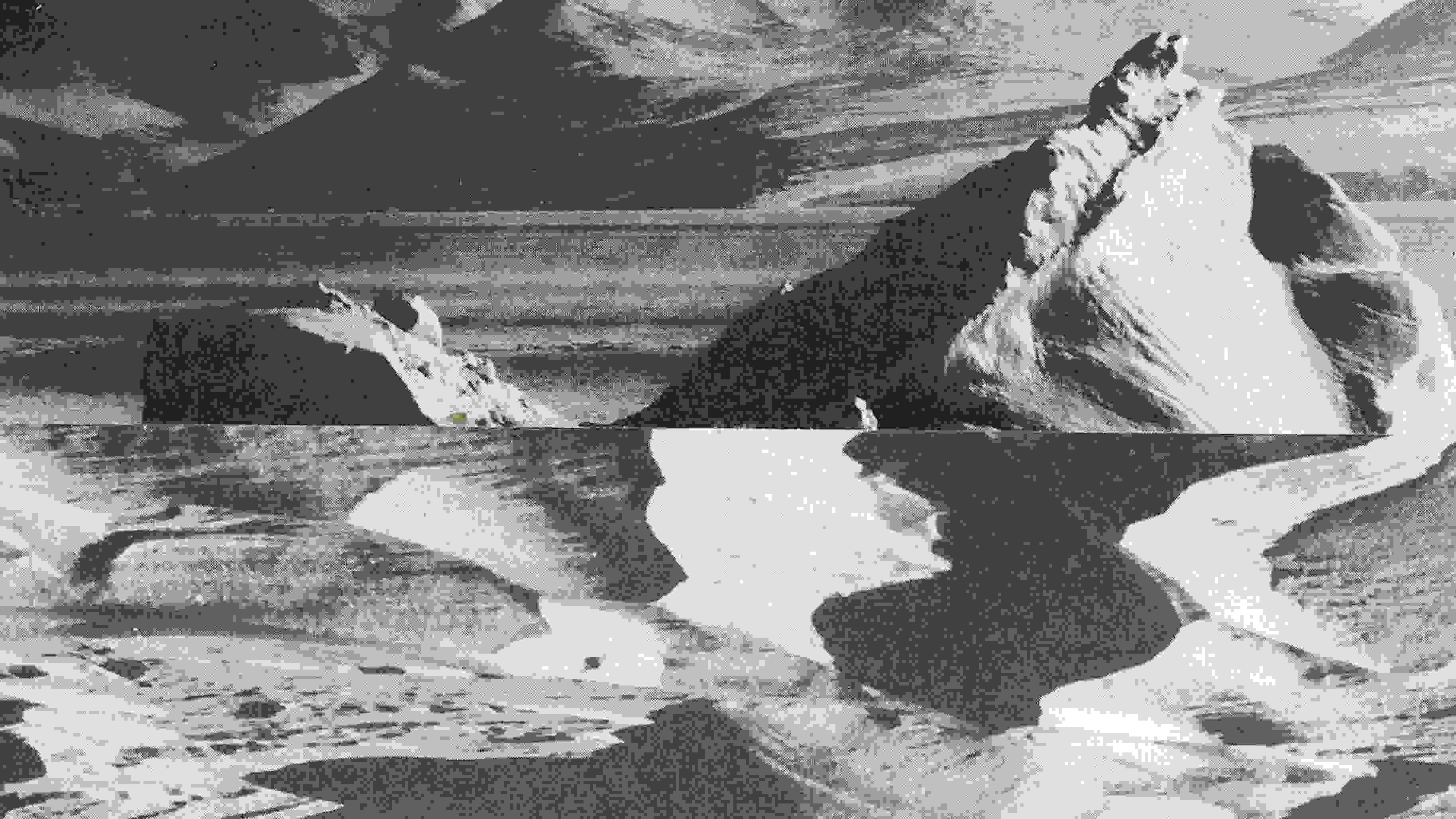 Black and white textured photograph of a mountainous landscape