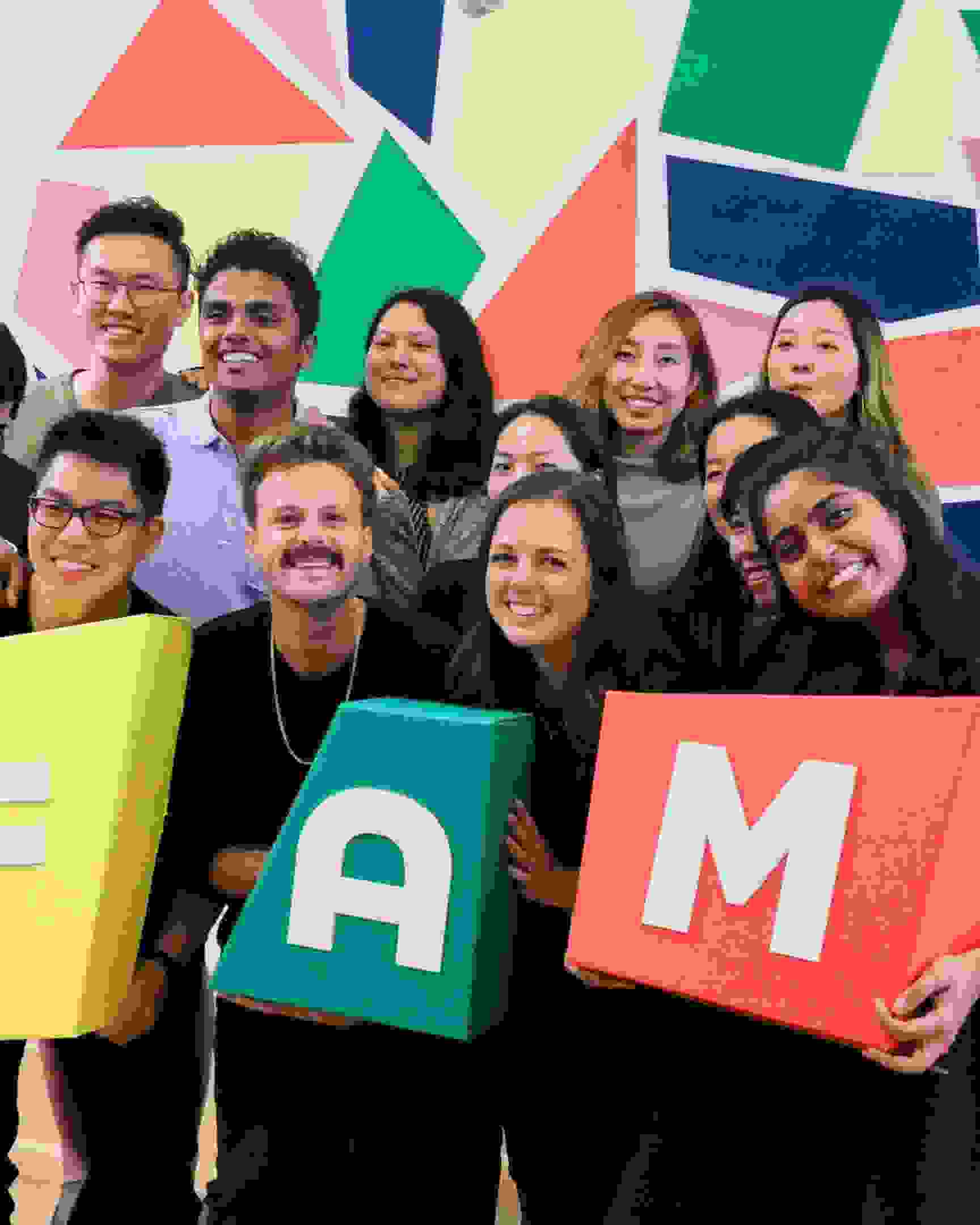 SVA MFA Design students holding a sign that says FAM