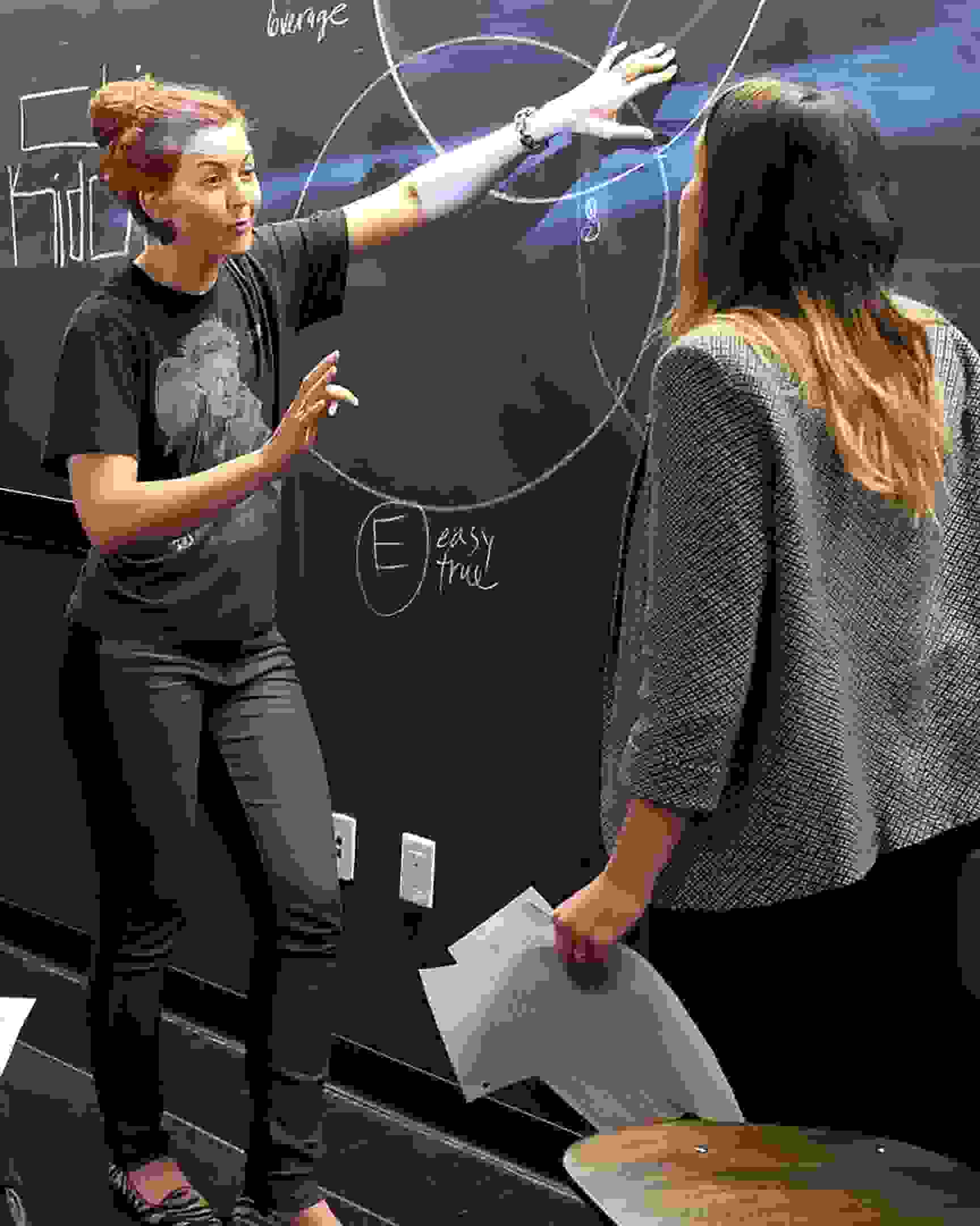 Professor presenting diagram to students