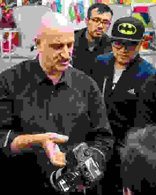 Professor demonstrating camera to students