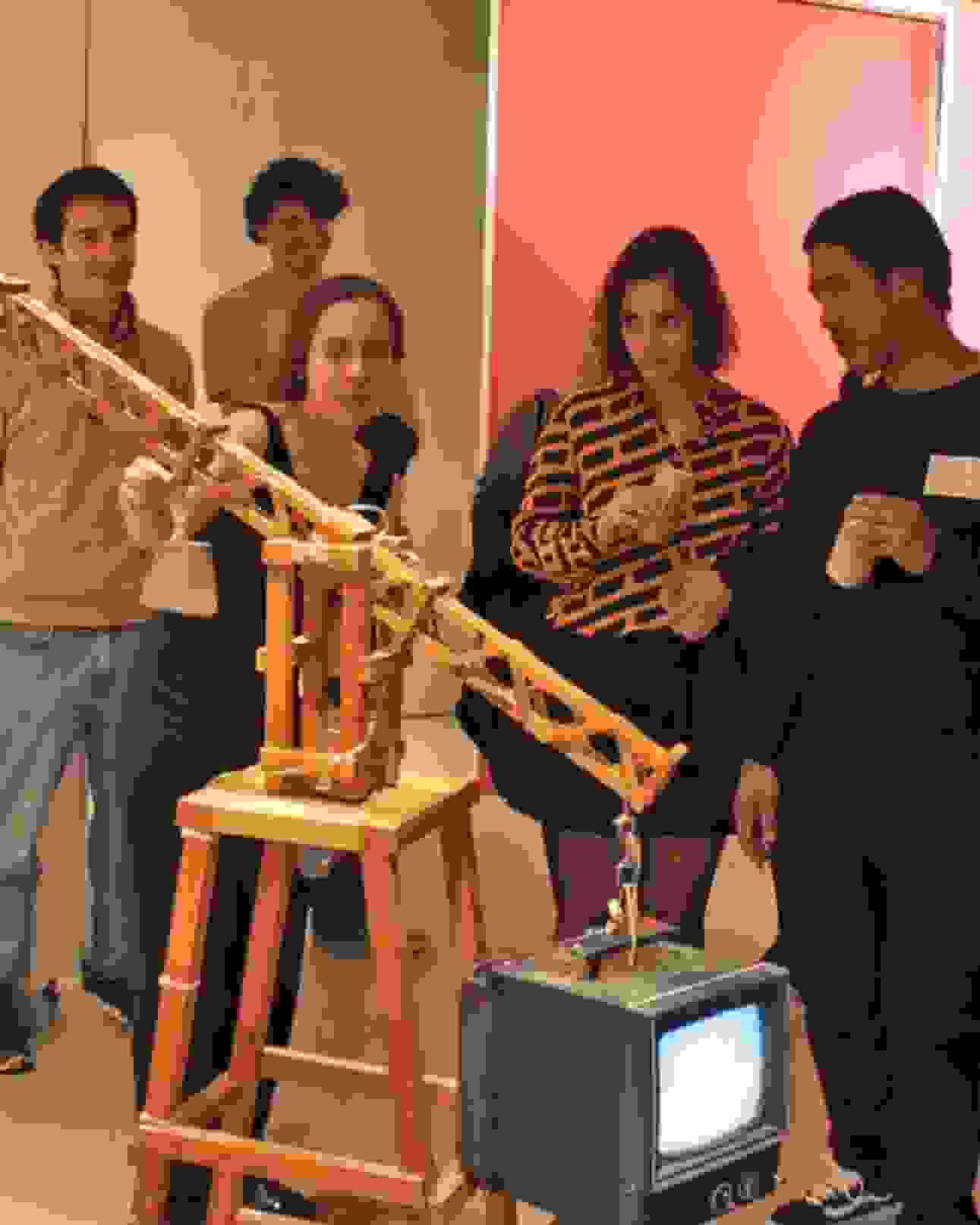 Class discussing a kinetic video sculpture