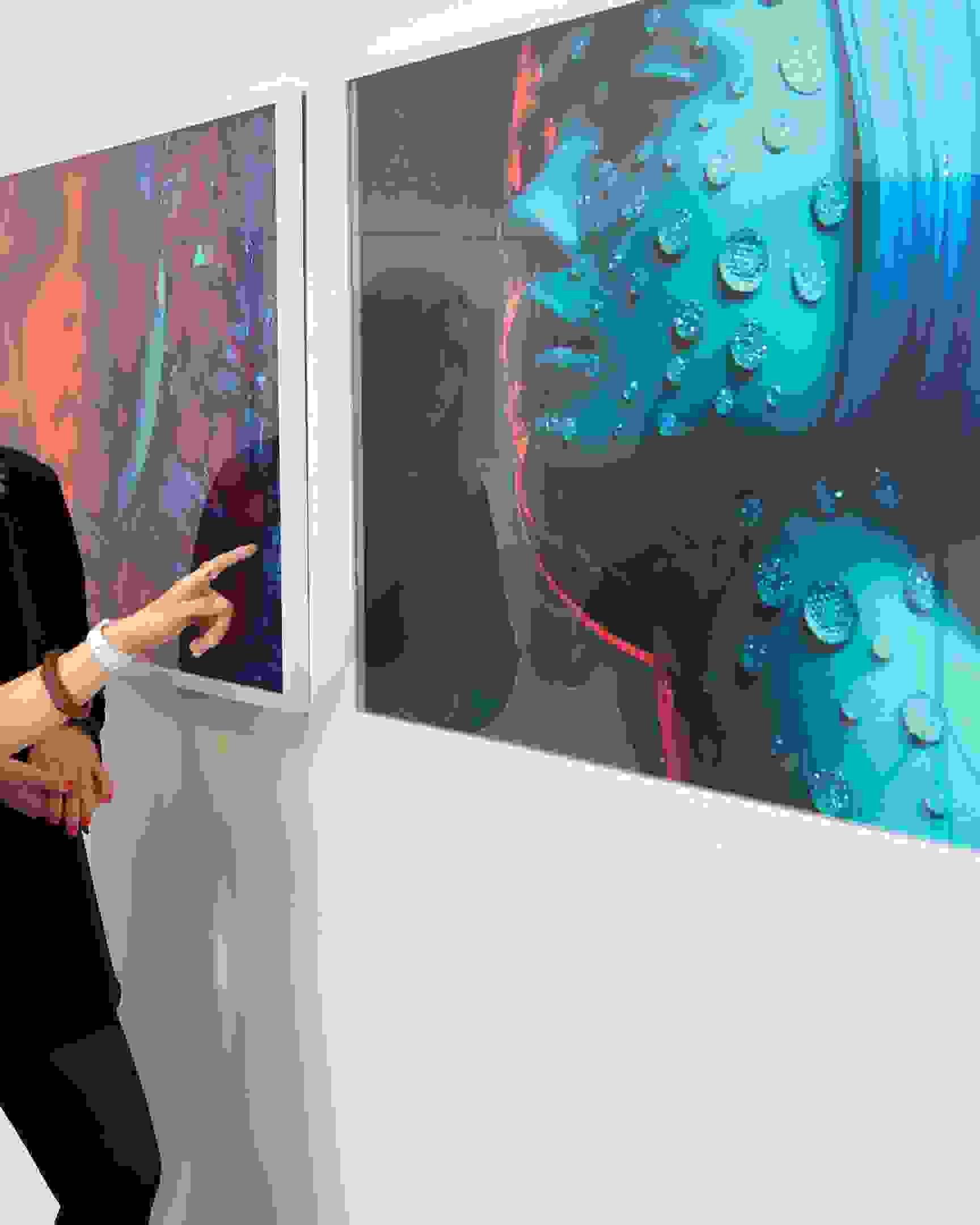 Two students discussing large framed fashion photograph