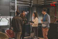 A group of people gather around motion capture equipment