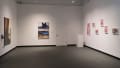 Looking into the SVA Gramercy Gallery, on the left wall is an image with headphones, on the far center wall are two framed photos with text beside it, and on the right are six photos hung apart.